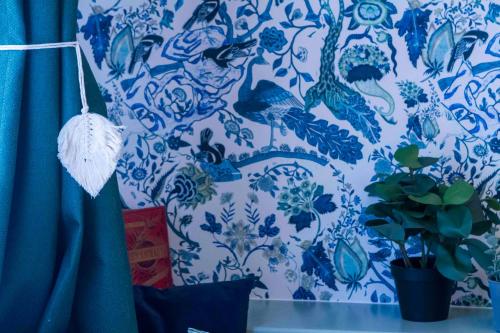 a blue and white patterned wall with a plant at Chalet Antoine serviced Apartments by Mirabeau in Zermatt