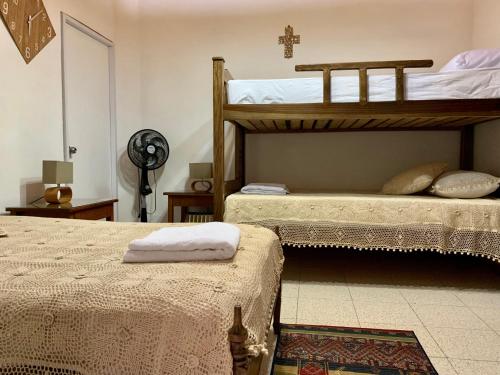 a bedroom with two bunk beds and a fan at Casa Grande in Medellín