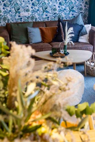 a living room with a couch and a coffee table at Chalet Antoine serviced Apartments by Mirabeau in Zermatt