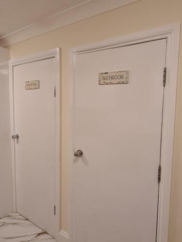 a white door with a sign on it in a room at Umbrella Properties London Excel in London