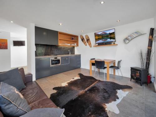 a living room with a couch and a table at Onyx 2a in Thredbo