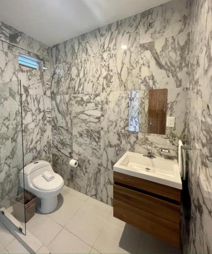 a bathroom with a toilet and a sink at Casa La Joya Bacalar in Bacalar