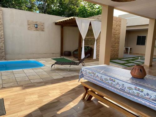 a backyard with a swimming pool and a patio at Casa Ondas de Alter in Alter do Chao