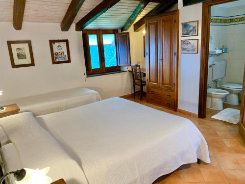 a bedroom with a bed and a bathroom with a toilet at Country house sant alfonso in Furore
