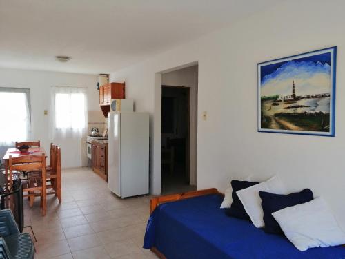 a room with a bed and a kitchen with a refrigerator at Las Dulcineas in La Paloma