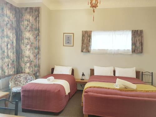 a room with two beds and a window at Dunedin Classic Stay in Dunedin