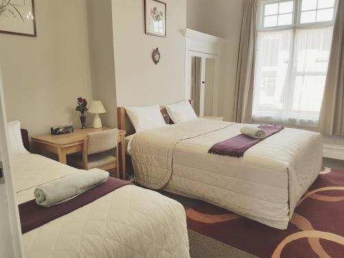 Postel nebo postele na pokoji v ubytování Dunedin Classic Stay