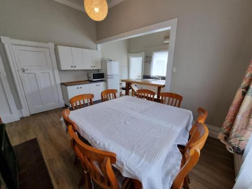 a kitchen with a table with a white table cloth at Dunedin Classic Stay in Dunedin