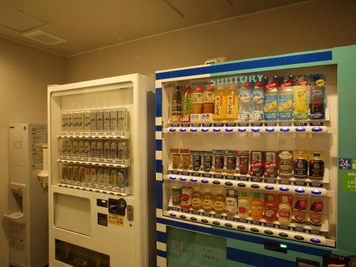 a vending machine filled with lots of bottles of soda at Green Rich Hotel & Capsule Naha - Artificial hot spring Futamata Yunohana in Naha