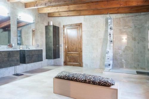 baño grande con banco frente a una puerta en Sestados, en Sa Pobla