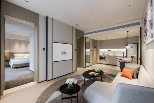 a living room with a couch and a tv at Modena by Fraser Nanjing in Nanjing