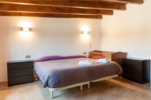 a bedroom with a bed with two towels on it at Sestados in Sa Pobla