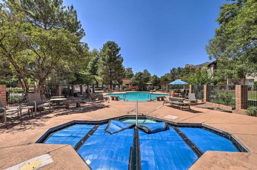 a swimming pool in a yard with a picnic table at Mtn-View Condo with Hot Tub Access in Sedona! in Sedona