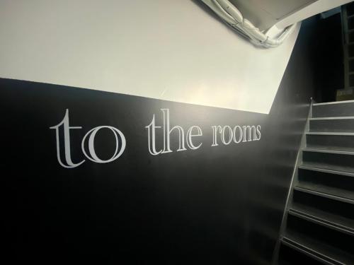a sign that reads to the roots next to stairs at Station Rooms in Winchester
