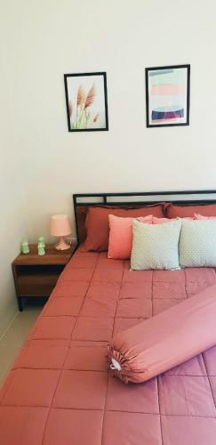 a large pink bed with pillows on it in a bedroom at Новый дом 106 м2, территория 160 м2 и своя парковка in Phuket Town