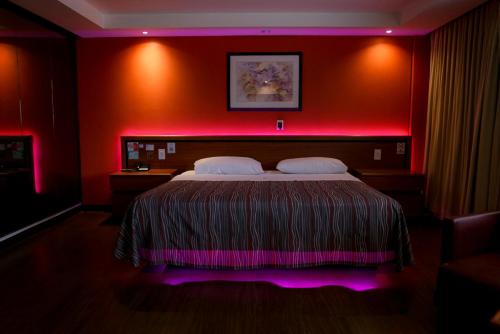 a bedroom with a bed with a pink lighting at Hotel Montreal in Mexico City