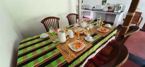 a table with a plate of food on it at Galaxy View Homestay Sigiriya in Sigiriya