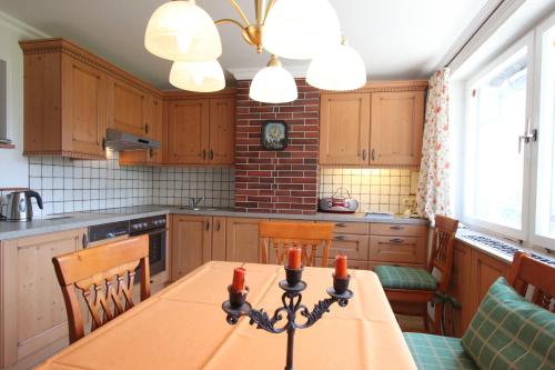 a kitchen with a table and some chairs in it at Stangl - Hof in Bad Aussee