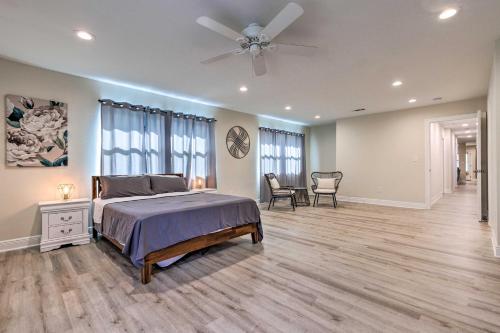 a bedroom with a bed and a ceiling fan at Spacious Gulfport Home with Yard 1 Mi to Beach in Gulfport