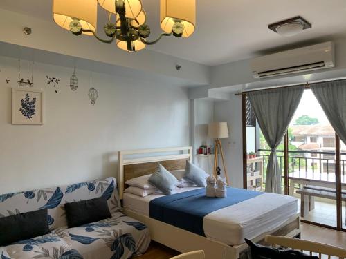 a bedroom with a bed and a couch at BIiss at Kasa Luntian with WIFI, Netflix and Nature s View in Tagaytay