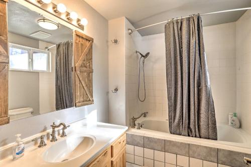 a bathroom with a sink and a tub and a shower at Pagosa Springs Gem with Yard, Decks and Mtn Views! in Pagosa Springs