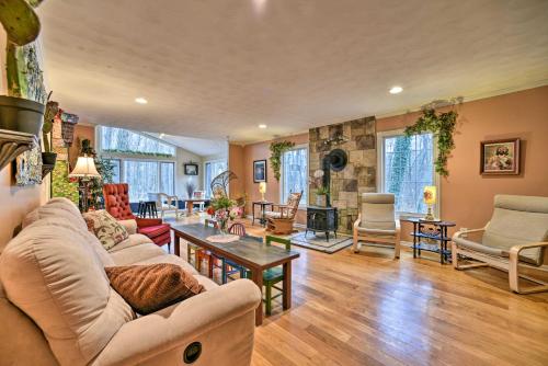 a living room with a couch and a table at Home on 10 Acres Perfect for MSU Football Weekend in Haslett