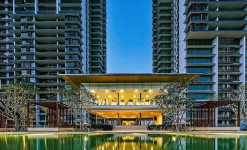 a building with a pool in front of some tall buildings at Iskandar Residences 3 Bedroom in Nusajaya