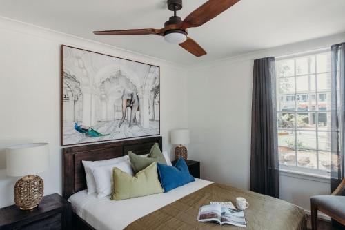 a bedroom with a bed and a ceiling fan at Nelson Palms in Nelson Bay