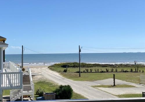 a view of the beach from the balcony of a beach house at Ohana home in Crystal Beach