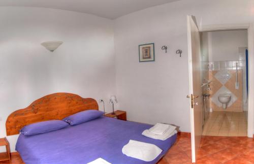 a bedroom with a blue bed and a shower at Agriturismo Ca' Di Trincia in Pietra Ligure
