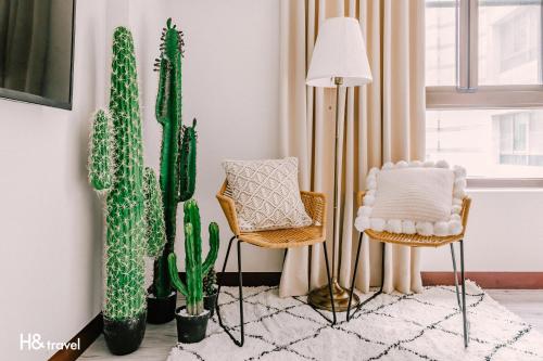 a living room with cactuses and chairs and a lamp at Tainan Haian Art Apartment in Tainan