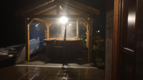 a hot tub in a gazebo at night at Kalabash Apartments in Sovata