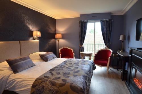 a hotel room with a bed and chairs and a window at Villa Augeval Hôtel de charme & Spa in Deauville
