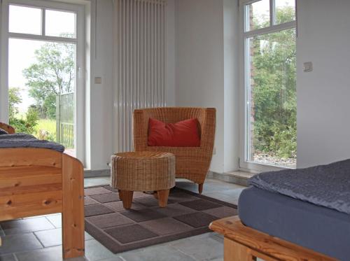 a bedroom with a wicker chair and a red pillow at Ferienhaus Polkvitz in Marlow