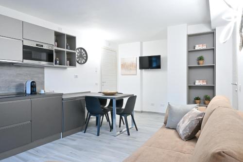 a kitchen and living room with a couch and a table at LakeSweetLakeComo in Como