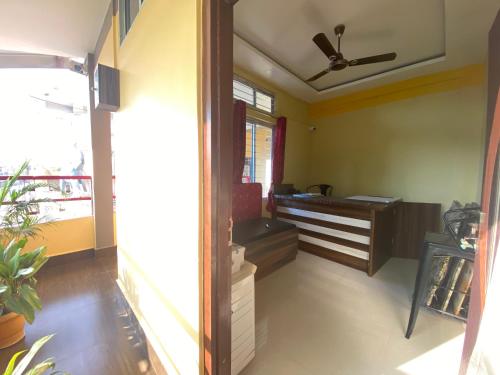 an office with a desk and a ceiling fan at APURBA GUEST HOUSE in Jorhāt