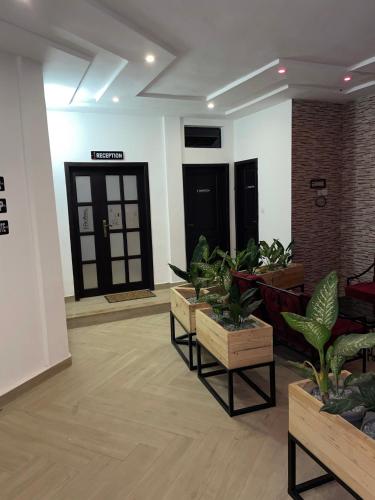 a room with a bunch of plants in it at HOTEL LES ARCADES in Abomey-Calavi