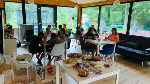 a group of people sitting at tables in a room at Chalupa u Bohumila in Rybná nad Zdobnicí