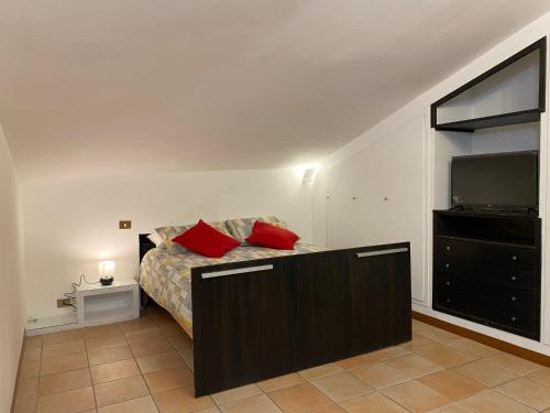 a bedroom with a bed and a flat screen tv at Frascati Roof 2 in Frascati