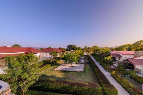 an overhead view of a yard with trees and houses at Astroport Sariska Treetop by Eight Continents in Tehla