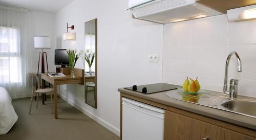 A kitchen or kitchenette at Terres de France - Appart'Hotel Quimper Bretagne