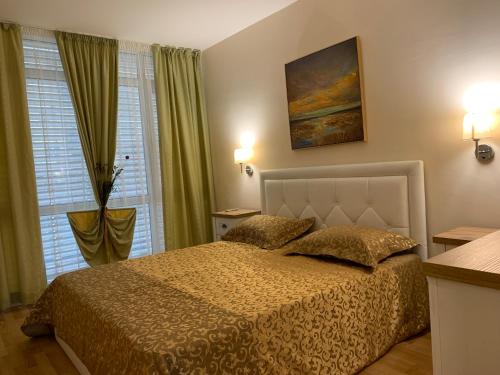 a bedroom with a bed and two pillows at Elite Apartments in Sunny Beach