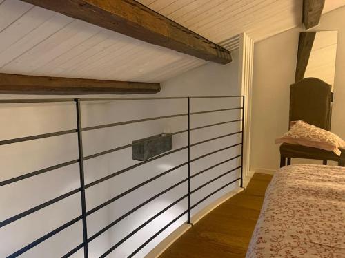 a bedroom with a bed and a wooden floor at La casetta rossa in Rimini