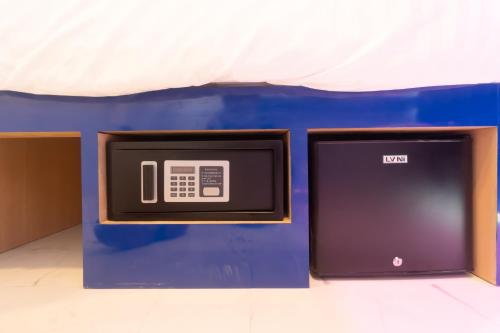 a box with a tv sitting on a table at Spark Hotel - MRT Queen Sirikit - SHA Extra Plus Certified in Bangkok