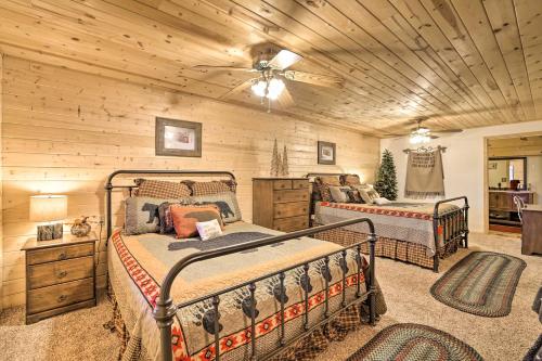 a bedroom with two beds and a wooden ceiling at Cozy Noras Hideaway - Charming, Quiet Log Cabin in Duck Creek Village