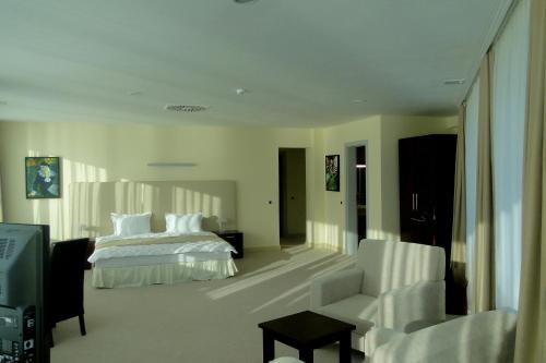 a hotel room with a bed and a television at Arena Hotel Kur in Mingachevir