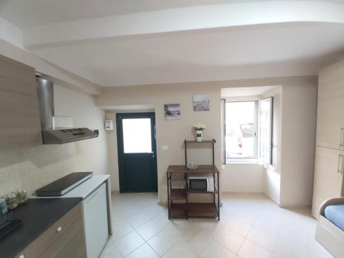 a kitchen with a table and a door in a room at Casa Doria in Alassio