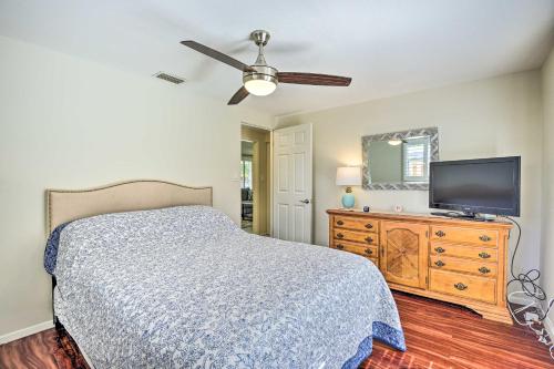 a bedroom with a bed and a flat screen tv at 1 Mi to Beach Nokomis Home with Private Pool in Nokomis