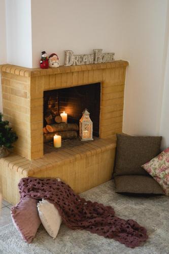a living room with a fireplace with two candles at Seaside Apartments in Áyios Vasílios