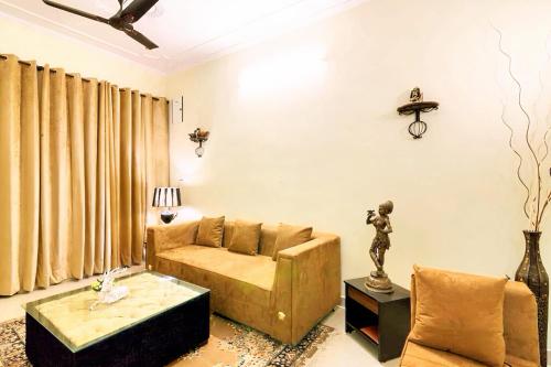 a living room with a couch and a table at The Buddhayan Villa in Jaipur